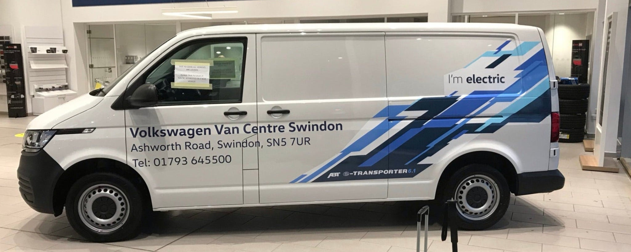 Volkswagen van with electric branding in a showroom setting